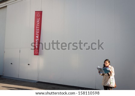 MILAN, ITALY - OCTOBER 11: Woman outside the building hosting Yoga Festival 2013, event dedicated to yoga, meditation and healthy lifestyle on OCTOBER 11, 2013 in Milan.