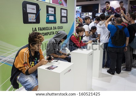 MILAN, ITALY - OCTOBER 26: People play at Games Week 2013, event dedicated to video games and electronic entertainment on OCTOBER 26, 2013 in Milan.