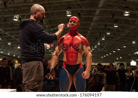 MILAN, ITALY - FEBRUARY 8: Bodybuilder during body painting session at Milano Tattoo Convention, international event dedicated to tattoos, body piercing and body painting on FEBRUARY 8, 2014 in Milan.
