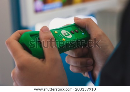 MILAN, ITALY - JULY 3, 2014: Close up of green Nintendo Wii mini controller. Nintendo is the world\'s largest video game company by revenue.