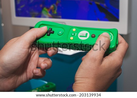 MILAN, ITALY - JULY 3, 2014: Close up of green Nintendo Wii mini controller. Nintendo is the world\'s largest video game company by revenue.
