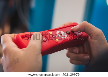 MILAN, ITALY - JULY 3, 2014: Close up of red Nintendo Wii mini controller. Nintendo is the world\'s largest video game company by revenue.