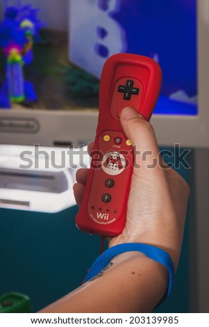 MILAN, ITALY - JULY 3, 2014: Close up of red Nintendo Wii mini controller. Nintendo is the world\'s largest video game company by revenue.