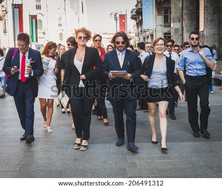 MILAN, ITALY - JULY 16: Business people take part in a flash mob to promote the official launch of The Wolf of Wall Street on DVD and Blue-Ray on July 16, 2014 in Milan.