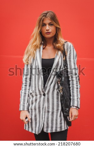 MILAN, ITALY - SEPTEMBER 18: Woman poses outside Costume National fashion shows building for Milan Women\'s Fashion Week on SEPTEMBER 18, 2014 in Milan.