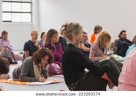 MILAN, ITALY - OCTOBER 10: People take a class at Yoga Festival, event dedicated to yoga, meditation and healthy lifestyle on OCTOBER 10, 2014 in Milan.