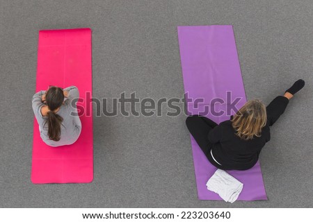 MILAN, ITALY - OCTOBER 10: Women take a class at Yoga Festival, event dedicated to yoga, meditation and healthy lifestyle on OCTOBER 10, 2014 in Milan.