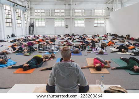MILAN, ITALY - OCTOBER 10: People take a class at Yoga Festival, event dedicated to yoga, meditation and healthy lifestyle on OCTOBER 10, 2014 in Milan.