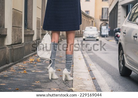 Detail of a beautiful girl with miniskirt posing in the city streets