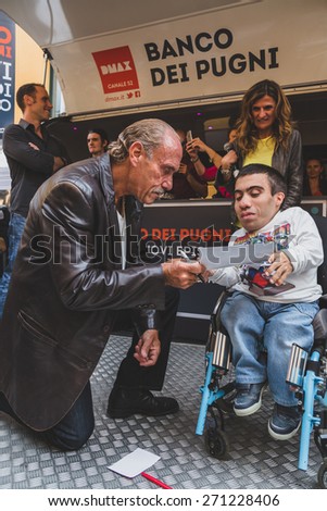 MILAN, ITALY - APRIL 18: Les Gold of the tv series Hardcore Pawn autographs a picture for a guy on wheelchair at Fuorisalone, important events during Milan Design Week on APRIL 18, 2015 in Milan.