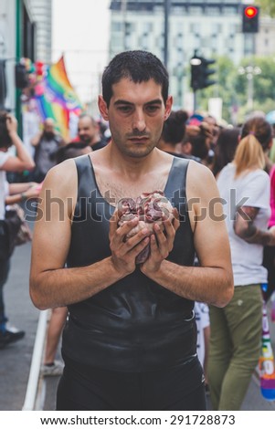 MILAN, ITALY - JUNE 27: Artist Nicola Mette during his performance with an animal heart at the Milano Pride on JUNE 27, 2015 in Milan.