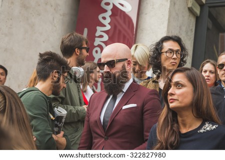 MILAN, ITALY - SEPTEMBER 27: People gather outside Ferragamo fashion show building for Milan Women\'s Fashion Week on SEPTEMBER 27, 2015  in Milan.