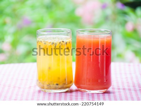 Passion fruit juice and papaya juice with flower garden background