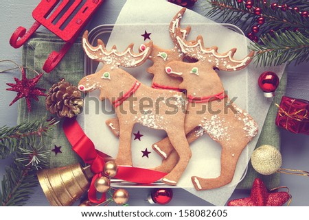 Homemade christmas elk-shaped cookies with christmas decoration, retro style