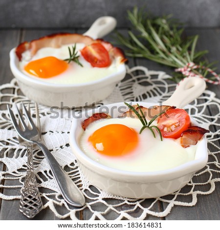 Fried egg in a ceramic pan for breakfast on wooden background