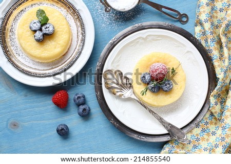 Lemon Surprise Pudding cake served with berries on plate
