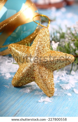 Christmas composition with gold star on blue wooden background