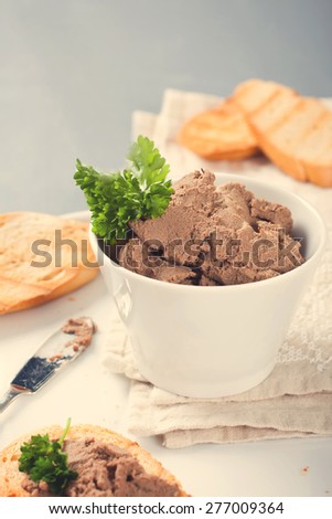 Healthy chicken liver pate with parsley in bawl,  selective focus. Retro vintage instagram filter.