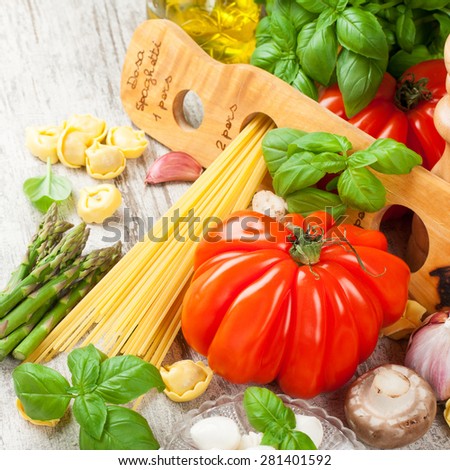 Italian food background. Ingredients for cooking, tomatoes, spaghetti, mushrooms, spaghetti meter on vintage white table. Healthy food concept.