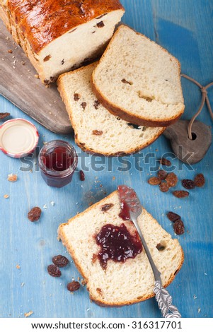 Tasty sliced raisin bread and jam for breakfast. Healthy food background. Top view.
