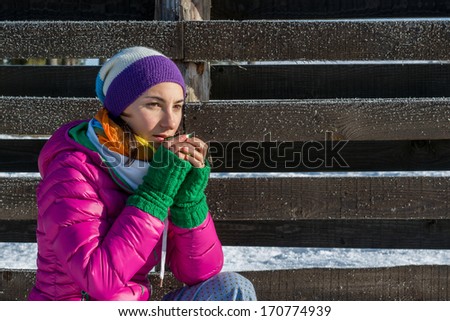 young woman sipping coffee from a thermos cup on a winter morning