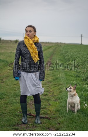portrait of girl and her dog in bad weather