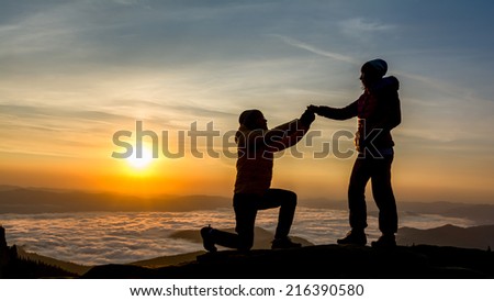 man asking his girlfriend if she wants to marry him. sunrise