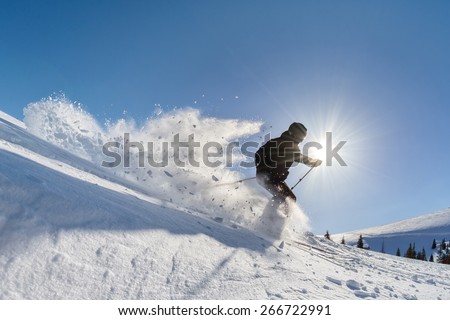 skier in deep powder on a steep slope