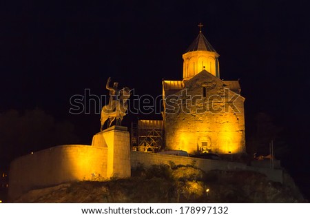 TBILISI, GEORGIA - JULY 03, 2013: Night view of the temple Metekhi and the monument to Vakhtang Gorgasali. The city Tbilisi has a population of 1.5 million people