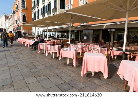 VENICE, ITALY - NOVEMBER 04, 2013: Open air restaurant or cafe in Venice Italy. Venice is one of the most popular tourist destinations in the world