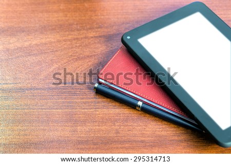 Workplace. Pen, tablet and notepad on the table. Place for text