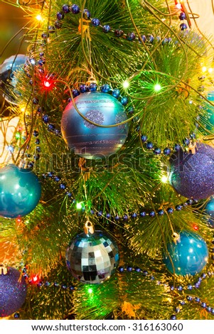 Christmas and New Year Decoration. Christmas ball hanging on a Christmas tree. Bright garlands