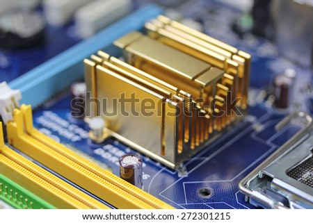 Golden radiator on blue microchip close up