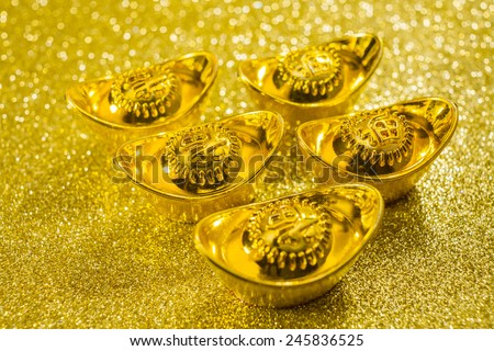 Gold bars on gold swirl background