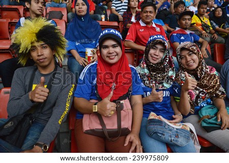 KL,Malaysia-DEC.20:Thai fans cheer during the competition 2014 AFF Suzuki Cup between Malaysia at Thailand Bukit Jalil stadium on December 20, 2014 in Kuala Lumpur,Malaysia