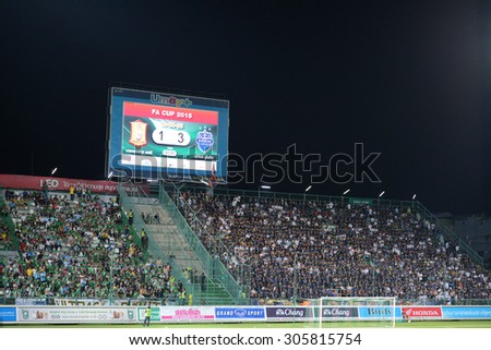 PATHUMTHANI, THAILAND- AUG12: Football fans on the stand cheer in action during Thai Premier League 2015 between BGFC and BuriramUtd at Leo Stadium on August 12, 2015 in Thailand.