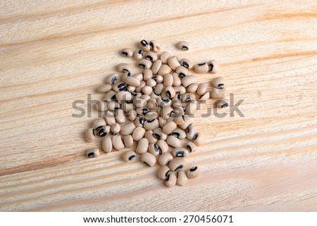 Handful of white beans on a wooden background
