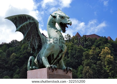 Slovenia Ljubljana Dragon at Zmajski Most with castle