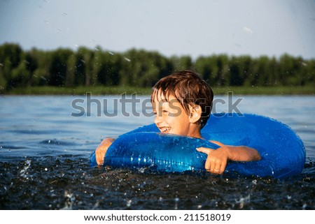 Boy relaxing on water tube