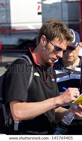 LONG POND, PA-JULY 6, 2013: Professional race driver Will Power greeting the crowd prior to qualifying for the Pocono 400 mile race at Long Pond on July 6, 2013.