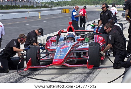 LONG POND, PA-JULY 6: Professional race driver Sebastien Bourdais practicing pit stops during practice for the Pocono 400 mile race at Long Pond on July 6, 2013.