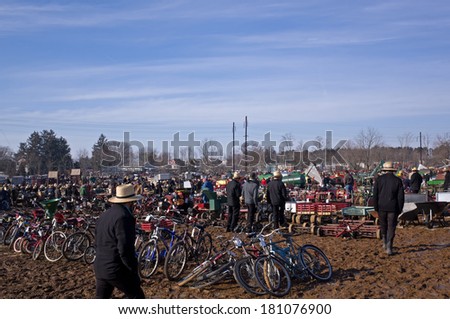 GORDONVILLE, PA, USA-MARCH 8, 2014: Amish and English shopping at the annual mud sale to benefit a fire company.  The sale attracts thousands of people. Items include quilts, antiques and buggies.