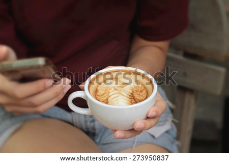 Woman drinking coffee in cup and smart phones