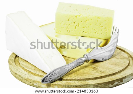 Pieces of cheese and cheese knife isolated on a white background