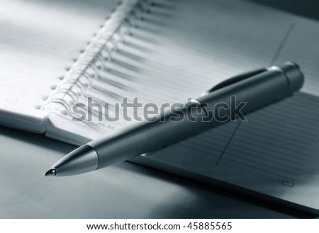 Pen and notepad in blue toned