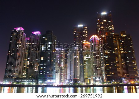 Busan, South Korea - March 26th of 2015: Night view of several buildings over the city\'s marine harbor.
