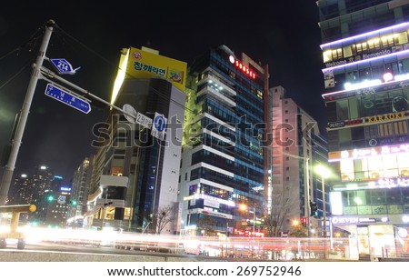 Busan, South Korea - March 26th of 2015: Night view of several buildings and main road in front of the beach.