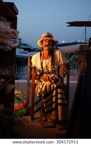 La Sabina, Formentera, Spain - August 5th of 2015: An old man sells his handmade souvenirs in a hippie market in Formentera. These trade markets are very common in the Balearic Islands in summer.