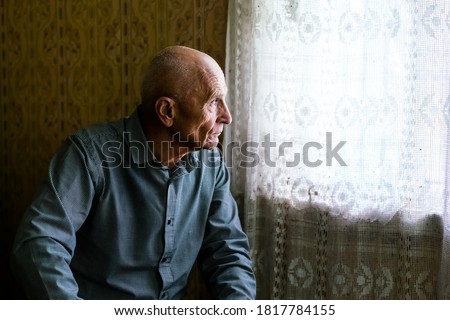Similar – Image, Stock Photo Elderly man looking through window in twilight