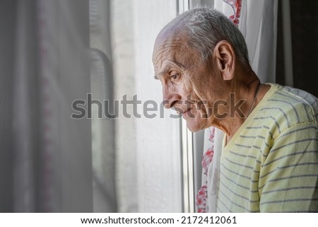 Image, Stock Photo Elderly man looking through window in twilight